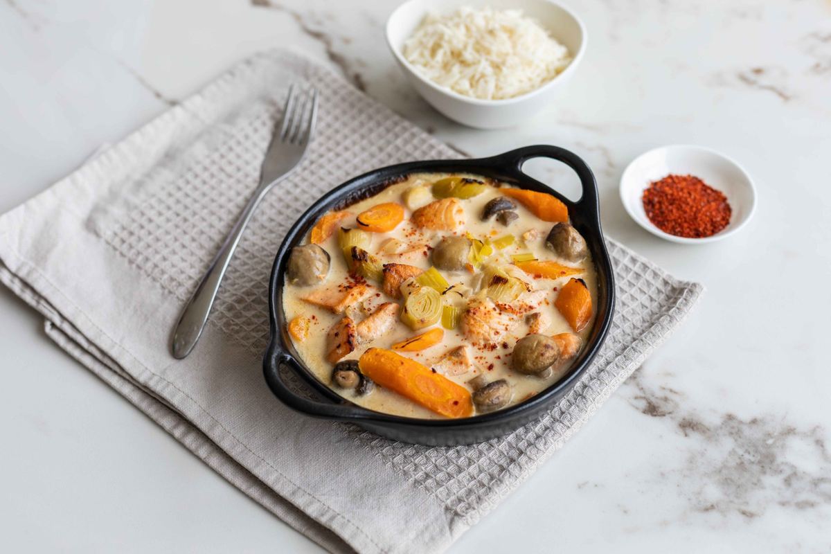 Plat crémeux aux légumes dans une cocotte noire, avec du riz